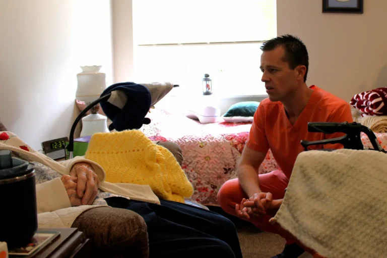 Dr. Jordan Sall of Emmanuel Hospice helping a patient